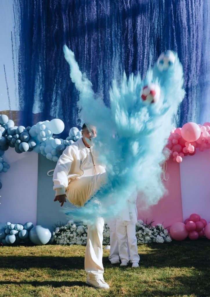 blue smoke display gender reveal with a football theme blue smoke display gender reveal with a football theme
