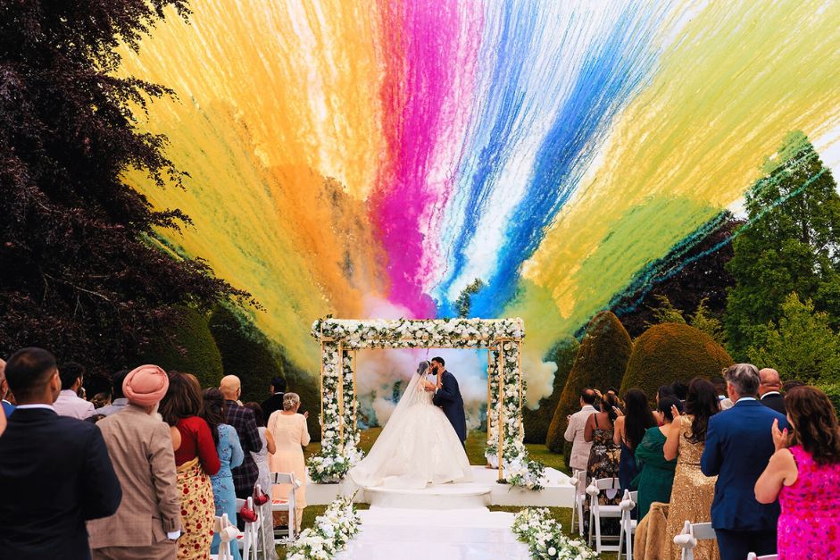 wedding featuring a smoke display colour arch, photo by Photo: @luke_makesphotos